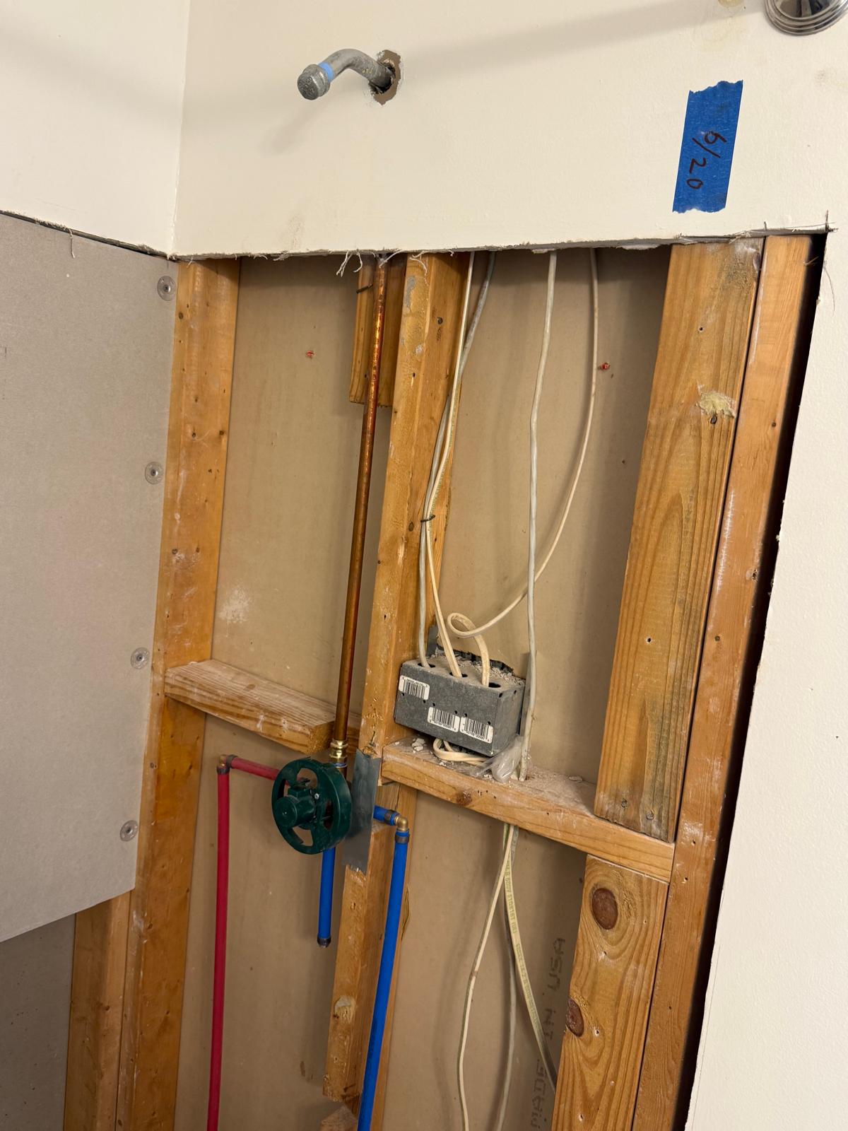 Shower wall opened to the studs with new PEX plumbing