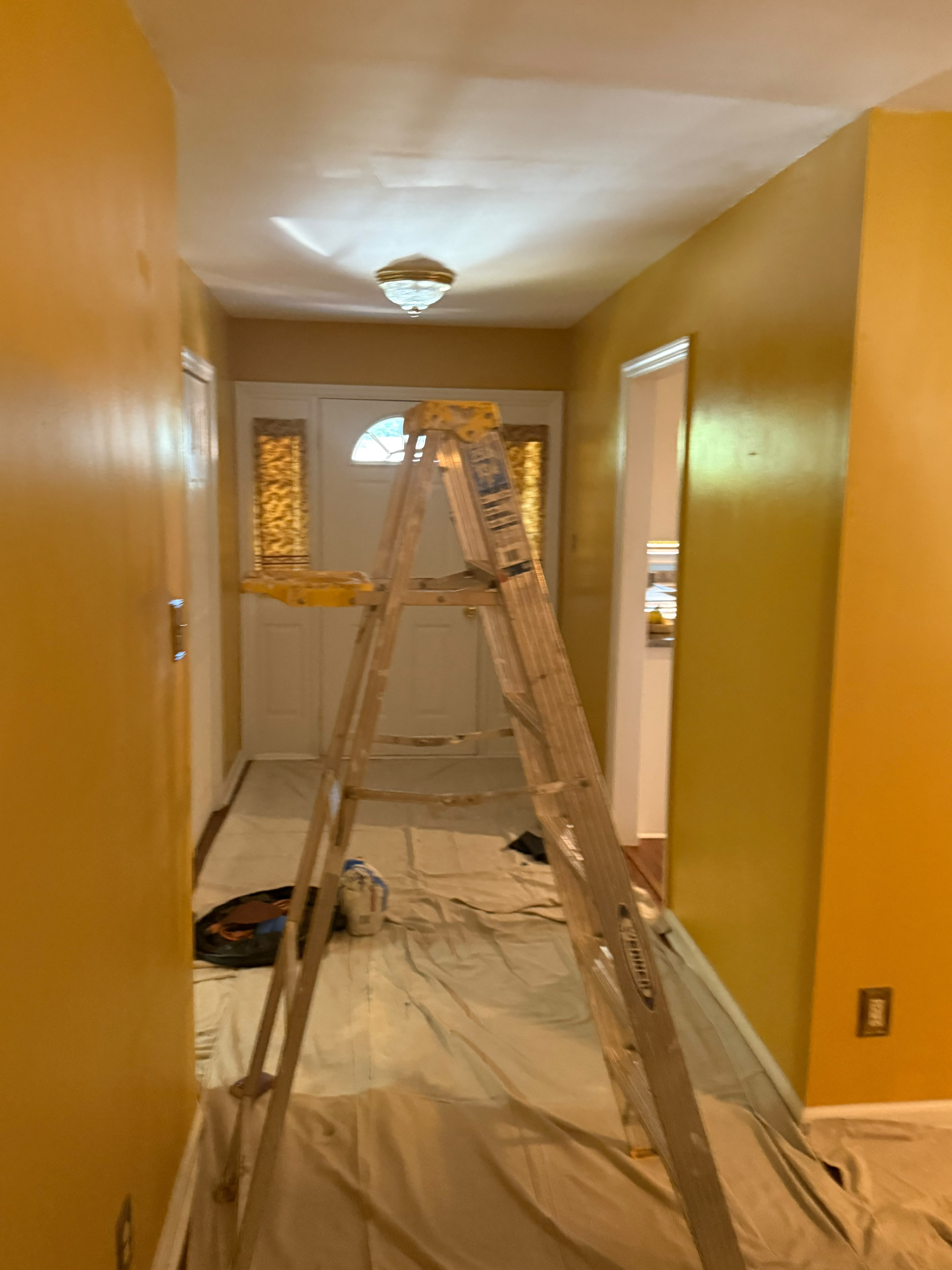 Old gold walls with patched spots ready for paint